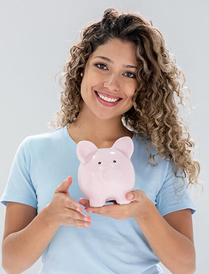 smiling woman holding a piggy bank