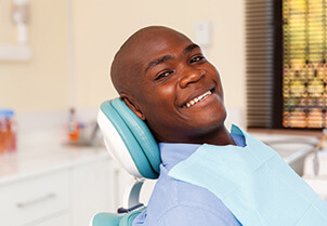 smiling man sitting in a dental chair