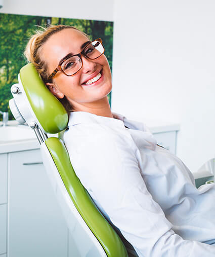 smiling woman sitting in a dental chair